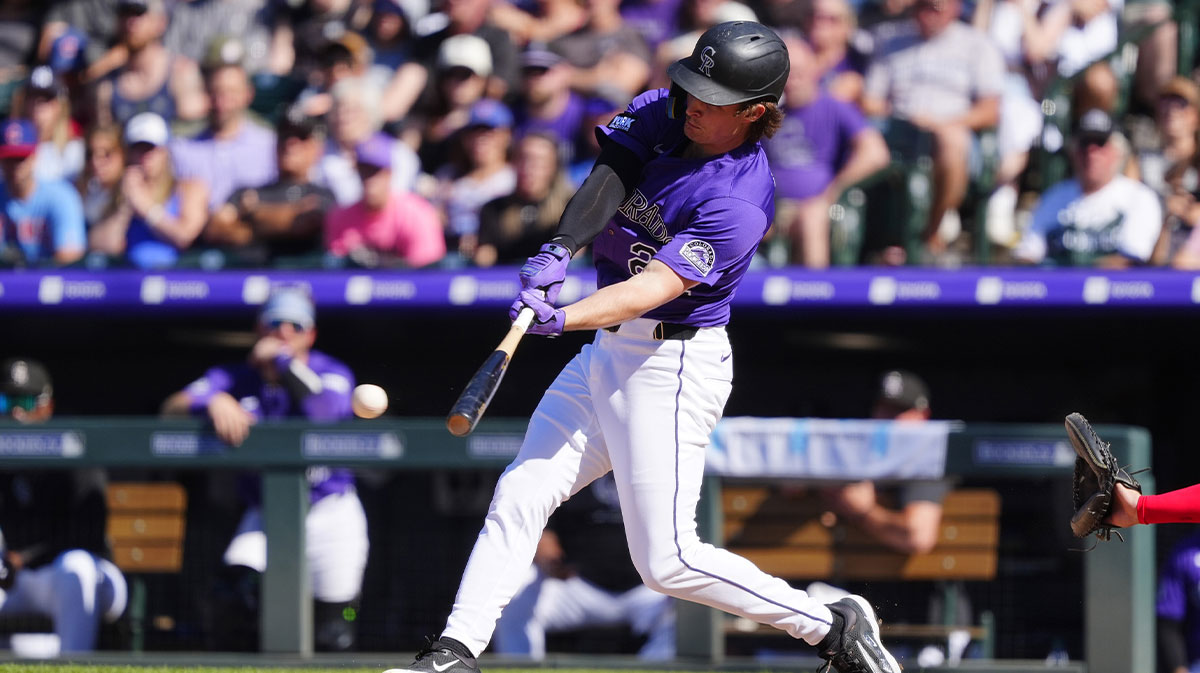 Colorado Rockies outfielder Mickey Moniak (22) hits a walk off triple in the ninth inning against the Chicago Cubs at Coors Field.