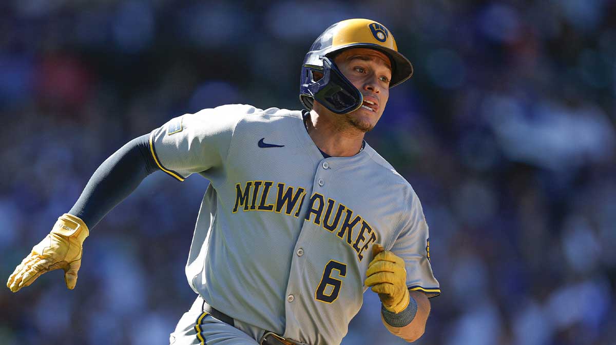 Milwaukee Brewers left fielder Isaac Collins (6) runs after hitting a two-run single against the Chicago Cubs during the eight inning at Wrigley Field.