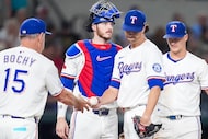 Texas Rangers pitcher Jacob deGrom hands the ball to manager Bruce Bochy as he exits during...
