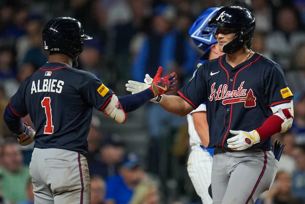 Atlanta Braves' Ha-Seong Kim, right, celebrates with Ozzie Albies after hitting a three-run...