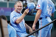 Texas Rangers manager Bruce Bochy tips his hat as he is razzed by his players before their...
