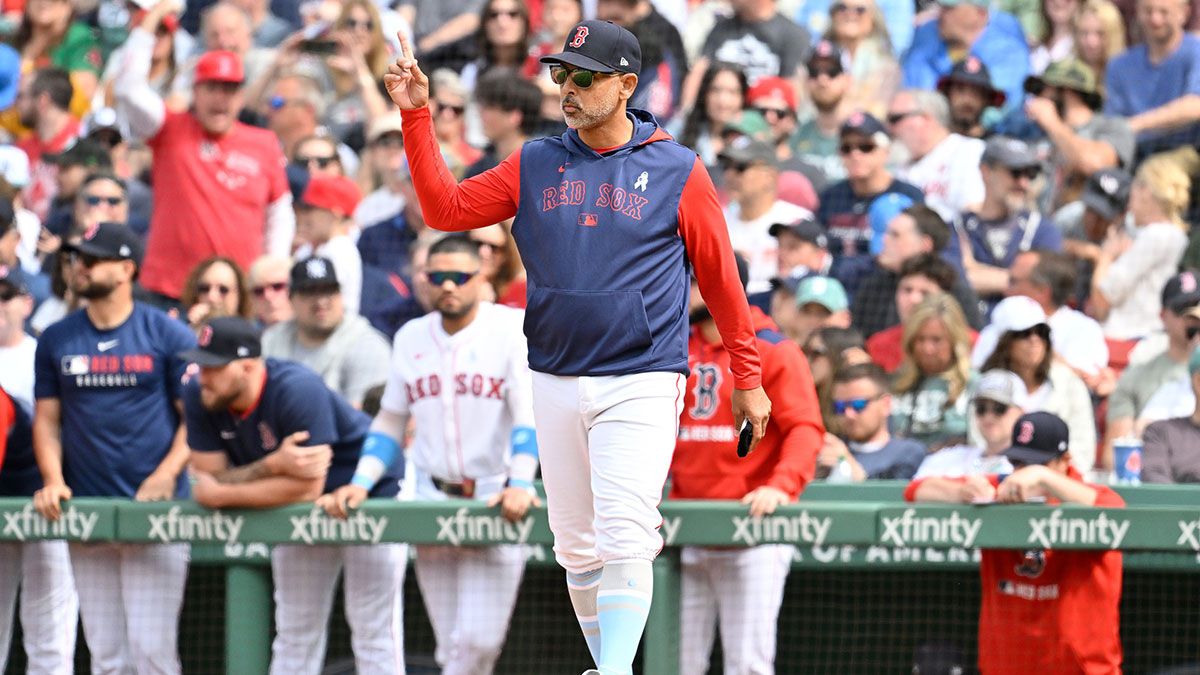Red Sox manager Alex Cora (13) signals to the bullpen during the eighth inning against the New York Yankees at Fenway Park