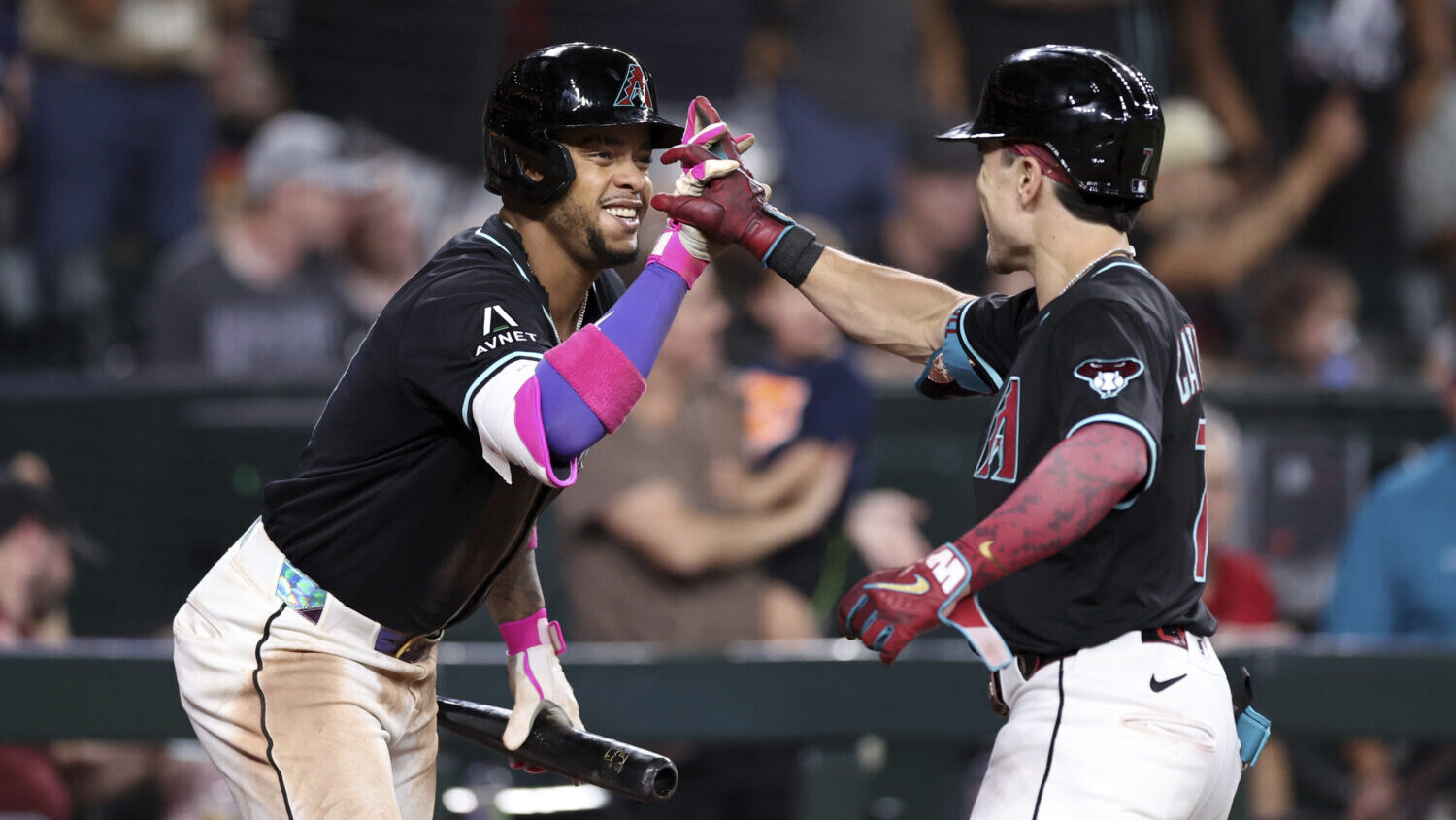 Arizona Diamondbacks' Corbin Carroll, right, high-fives Ketel Marte, as the D-backs remain in the N...