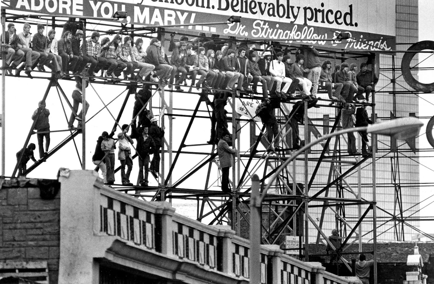 Fans without tickets to Game 1 of the World Series watched from a billboard on Lansdowne Street outside of Fenway Park.