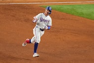 Texas Rangers' Michael Helman reacts after hitting a grand slam home run off Milwaukee...