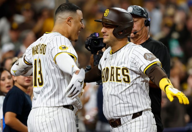 Jose Iglesias #7 of the San Diego Padres celebrates with Manny Machado #13 after hitting a solo home run in the fifth inning against the Milwaukee Brewers at Petco Park on Sept. 22, 2025 in San Diego, CA. (K.C. Alfred / The San Diego Union-Tribune)