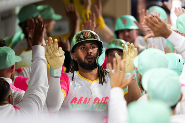 Fernando Tatis Jr. #23 of the San Diego Padres is congratulated in the dugout after hitting a grand slam against the Arizona Diamondbacks during the fifth inning at the Petco Park on Friday, Sept. 26, 2025 in San Diego, California. (Meg McLaughlin / The San Diego Union-Tribune)