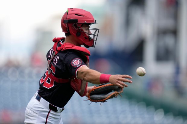 Washington Nationals catcher CJ Stubbs throws out Miami Marlins' Xavier Edwards at first base during the first inning of a baseball game at Nationals Park, Monday, Sept. 1, 2025, in Washington. This marks Stubbs' Major League debut. (AP Photo/Jess Rapfogel)