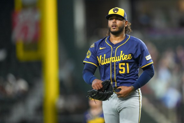 Milwaukee Brewers starting pitcher Freddy Peralta leaves the field after pitching to the Texas Rangers during the first inning of a baseball game Wednesday, Sept. 10, 2025, in Arlington, Texas. (AP Photo/Julio Cortez)