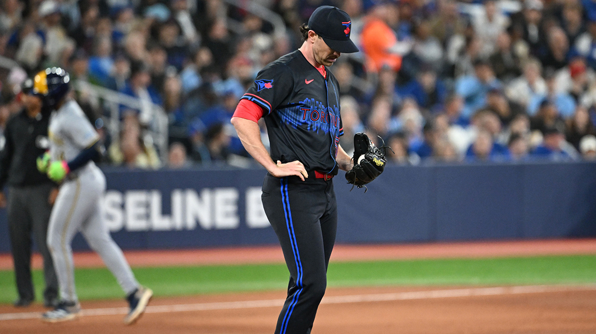 Toronto Blue Jays pitcher Shane Bieber (57) prepares for his next pitch as Milwaukee Brewers shortstop Andruw Monasterio (14) rounds the bases after hitting a solo home run in the sixth inning at Rogers Centre. 