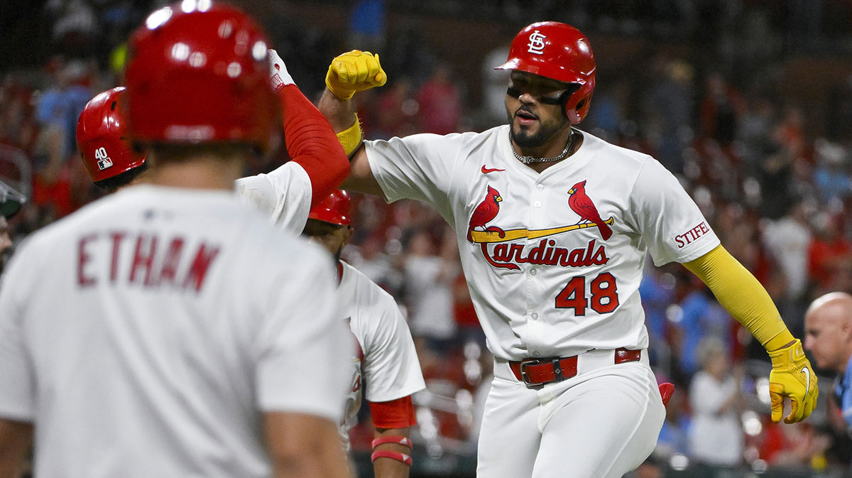 St. Louis Cardinals designated hitter Ivan Herrera (48) celebrates with center fielder Victor Scott II (11) and first baseman Willson Contreras (40) after hitting a two run home run against the Athletics during the sixth inning at Busch Stadium.