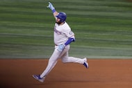 Texas Rangers first base Jake Burger (21) runs the bases after hitting a home run during the...
