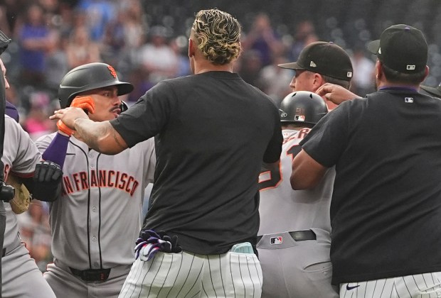 San Francisco Giants' Willy Adames, back left, squares off with Colorado Rockies starting pitcher Kyle Freeland, back right, after Freeland exchanged words with the Giants' Rafael Devers following Devers' two-run home run in the first inning of a baseball game Tuesday, Sept. 2, 2025, in Denver. (AP Photo/David Zalubowski)