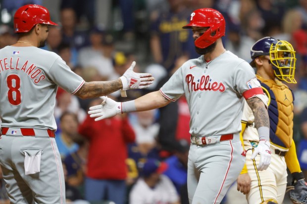 Philadelphia Phillies' Weston Wilson (37) reacts with Nick Castellanos after his two-run home run against the Milwaukee Brewers during the seventh inning of a baseball game, Wednesday, Sept. 3, 2025, in Milwaukee. (AP Photo/Jeffrey Phelps)