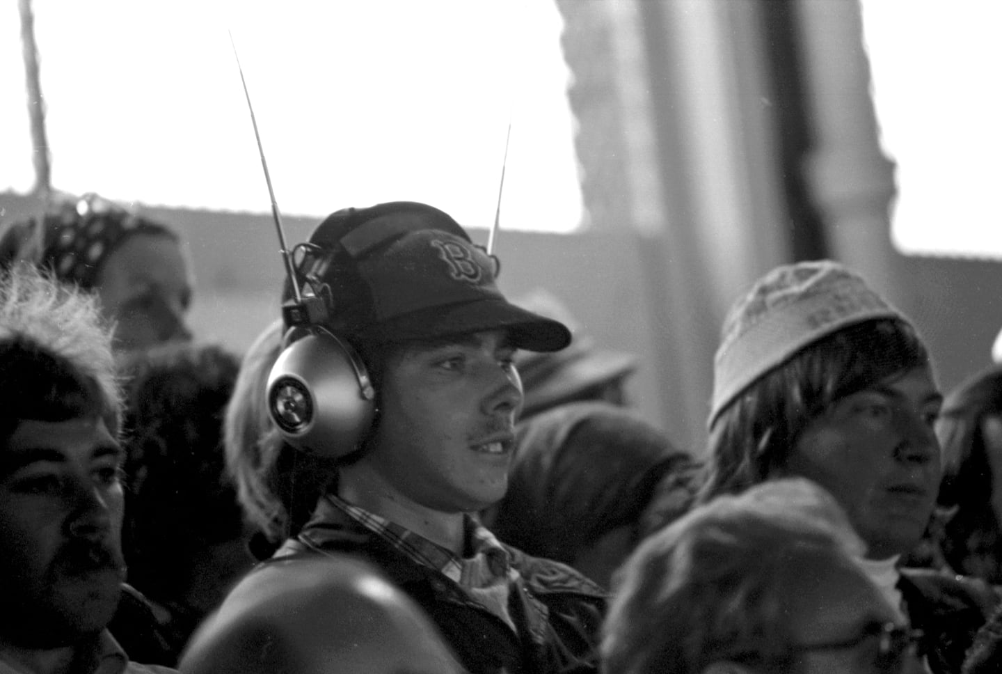 A Red Sox fan listened to Game 2 on his headset radio.