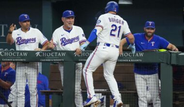 Texas Rangers' Jake Burger (21) is greeted near the dugout by bench coach Luis Urueta, left, manager Bruce Bochy, second from left, and hitting coach Justin Viele after hitting a solo home run off Milwaukee Brewers starting pitcher Freddy Peralta during the second inning of a baseball game Wednesday, Sept. 10, 2025, in Arlington, Texas. (AP Photo/Julio Cortez)