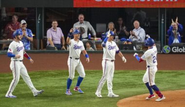 Texas Rangers' Michael Helman, right, is greeted near home plate by teammates, from left, Jonah Heim, Dylan Moore and Kyle Higashioka after scoring them all on a grand slam off Milwaukee Brewers starting pitcher Jose Quintana during the fifth inning of a baseball game Monday, Sept. 8, 2025, in Arlington, Texas. (AP Photo/Julio Cortez)