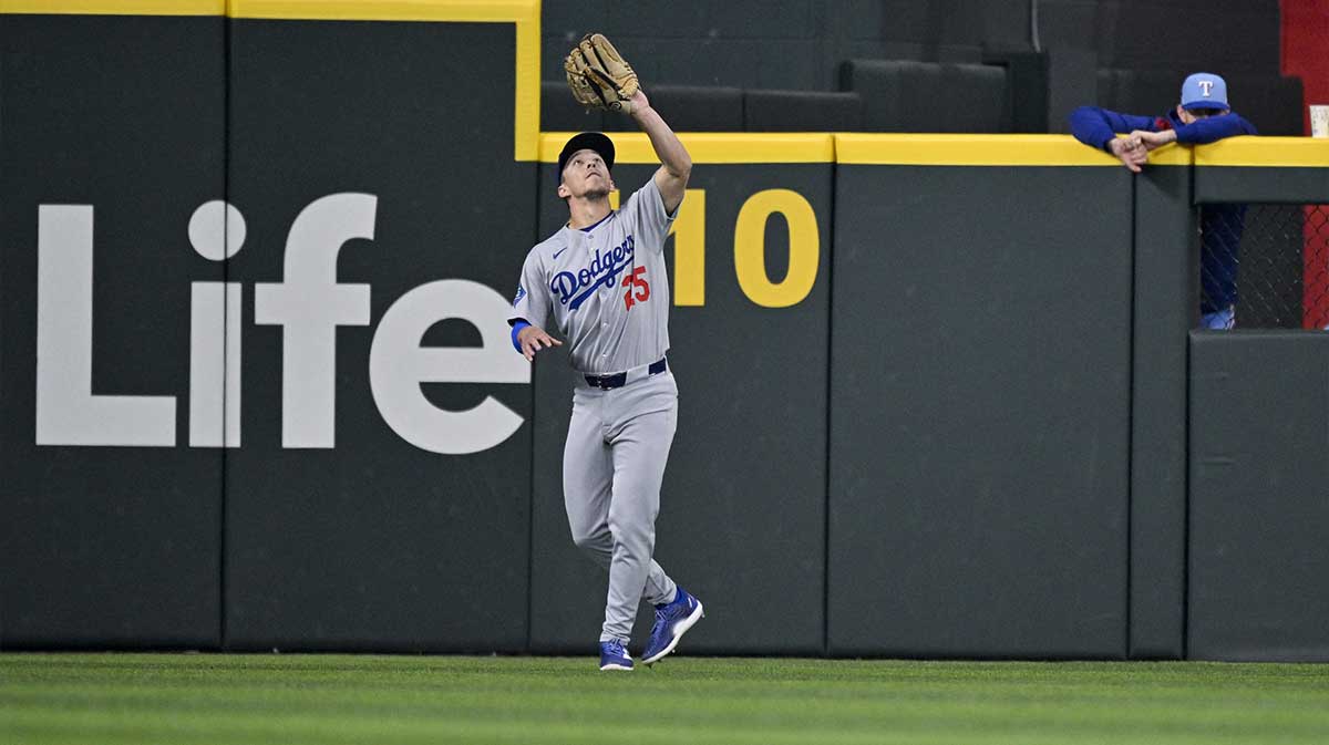 Los Angeles Dodgers center fielder Tommy Edman (25) catches a fly ball hit by Texas Rangers catcher Jonah Heim (not pictured) during the eighth inning at Globe Life Field.