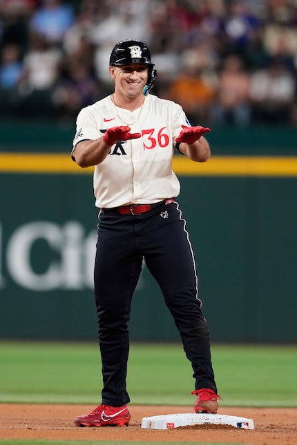 Texas Rangers' Wyatt Langford celebrates his double in the first inning of a baseball game...