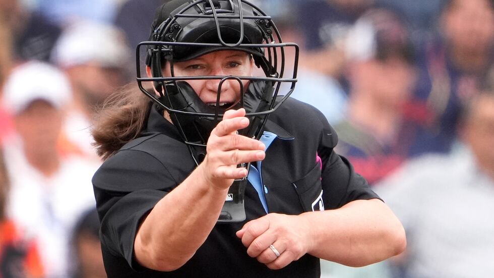 FILE - Home plate umpire Jen Pawol calls a strike during the third inning of a spring training...