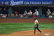 Texas Rangers' Adolis García looks on after striking out to end the fourth inning of a...