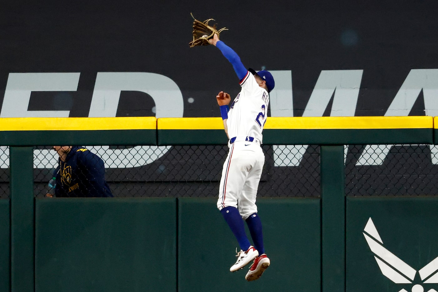Texas Rangers center fielder Michael Helman (24) makes a leaping catch at the wall  for an...