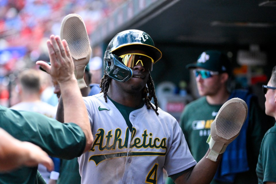 Lawrence Butler, #4, of the Oakland Athletics high-fives a teammate.