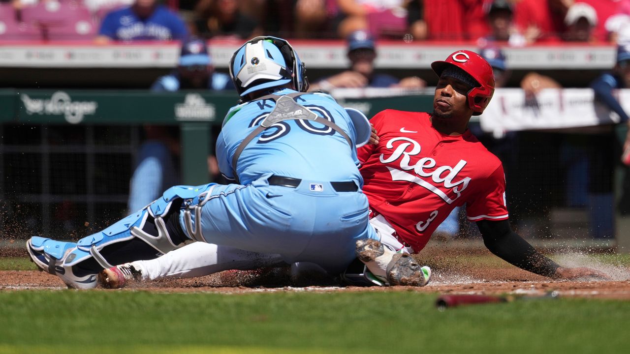Cincinnati Reds' Ke'Bryan Hayes, right, is tagged out at home plate by Toronto Blue Jays' Alejandro Kirk, left, in the second inning of a baseball game Monday, Sept. 1, 2025, in Cincinnati. (AP Photo/Kareem Elgazzar)