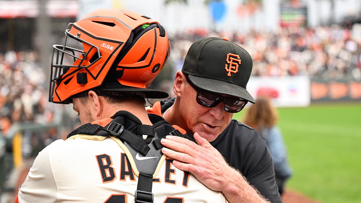 Bob Melvin hugs Patrick Bailey