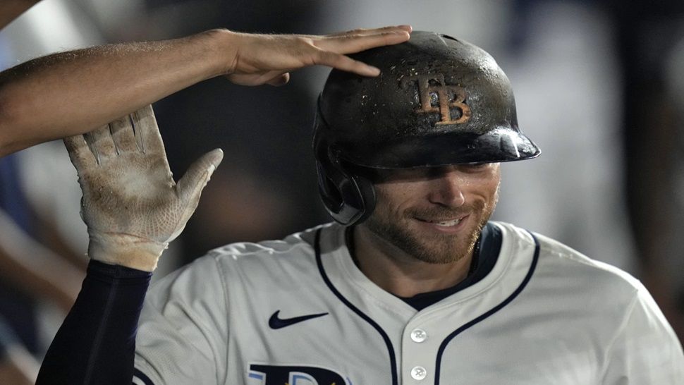Tampa Bay Rays' Brandon Lowe celebrates in the dugout after his solo home run off Boston Red Sox pitcher Steven Matz during the sixth inning of a baseball game Sunday, Sept. 21, 2025, in Tampa, Fla. (AP Photo/Chris O'Meara)