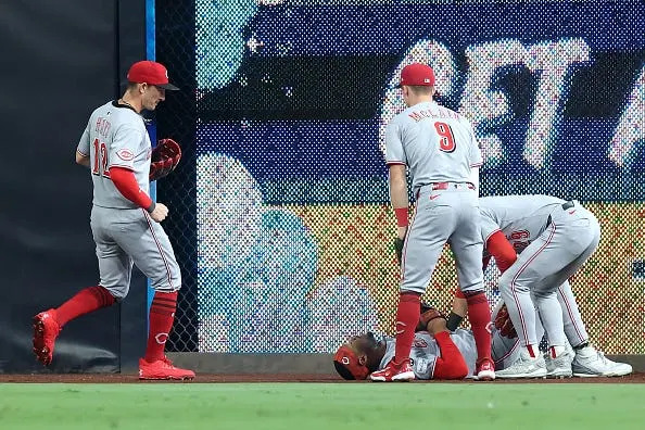 TJ Friedl, Matt McLain, and Austin Hays, come to the aid of Will Benson of the Cincinnati Reds
