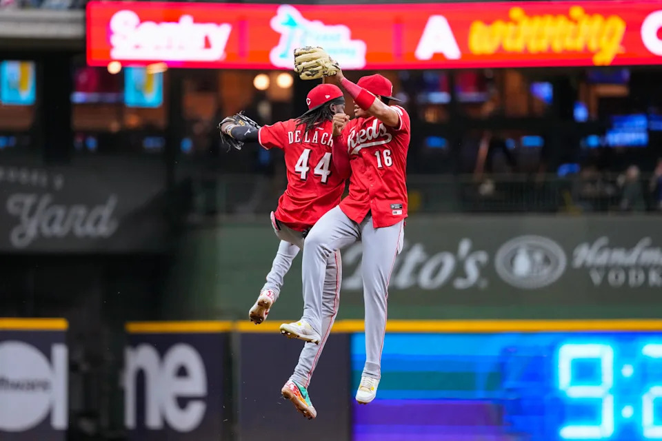 Shortstop Elly De La Cruz and right fielder Noelvi Marte celebrate following the Reds' 3-1 victory over the Milwaukee Brewers at American Family Field on Sept. 26. The victory moved the Red into the final NL playoff position by virtue of their tiebreaker advantage over the New York Mets.