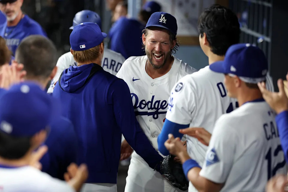 Los Angeles Dodgers pitcher Clayton Kershaw (22) is greeted by pitcher Yoshinobu Yamamoto (left) and designated hitter Shohei Ohtani (right) after being relieved during the fifth inning against the San Francisco Giants at Dodger Stadium in Los Angeles on Sept. 19, 2025.