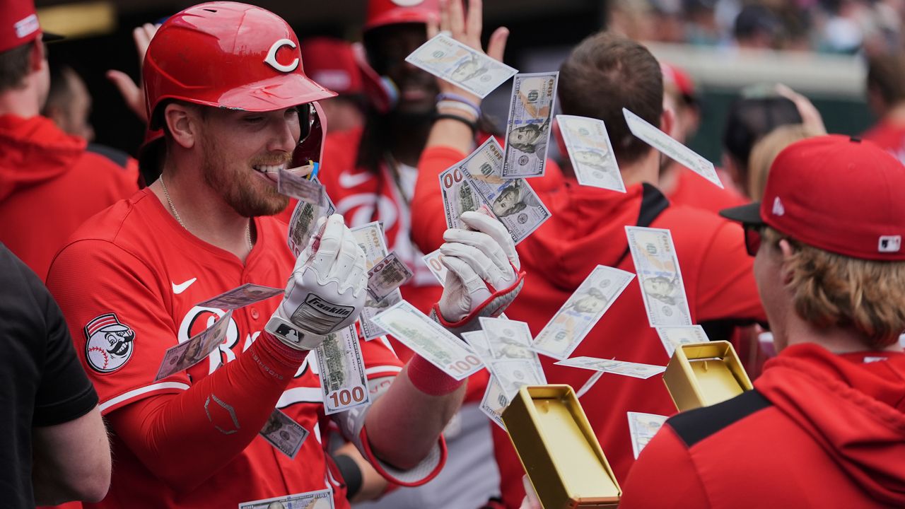 Cincinnati Reds' Tyler Stephenson, left, celebrates his grand slam against the Detroit Tigers in the fifth inning during a baseball game, Saturday, June 14, 2025, in Detroit. (AP Photo/Paul Sancya)