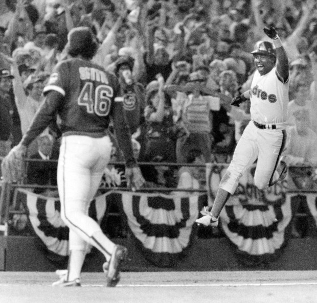 Cubs' reliever Lee Smith stalks off the mound while the Padres' Tony Gwynn leaps in the air after the Padres' Steve Garvey's playoff homer in San Diego on Oct. 2, 1984, during the NLCS. (Ed Wagner Jr./Chicago Tribune)