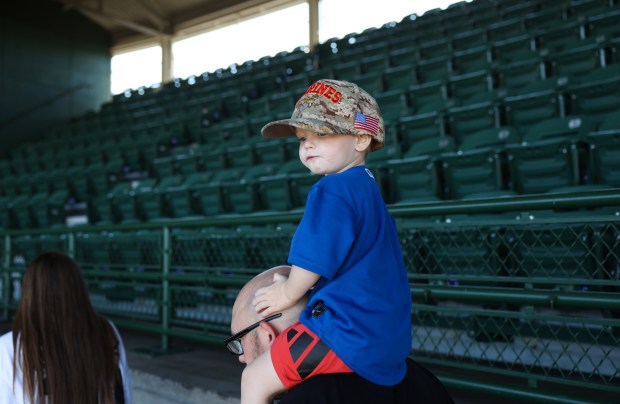 Shawn Stephens, 2, sits on his father Devin's shoulder as they walk through the upper deck before a Cubs-Braves game at Wrigley Field on Sept. 1, 2025, in Chicago. (John J. Kim/Chicago Tribune)