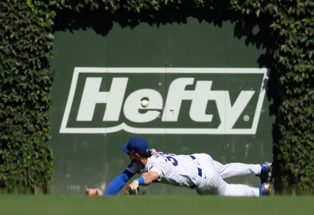 Cubs right fielder Kyle Tucker dives for a ball hit by Braves center fielder Michael Harris II for a two-run single in the third inning at Wrigley Field on Sept. 1, 2025, in Chicago. (John J. Kim/Chicago Tribune)