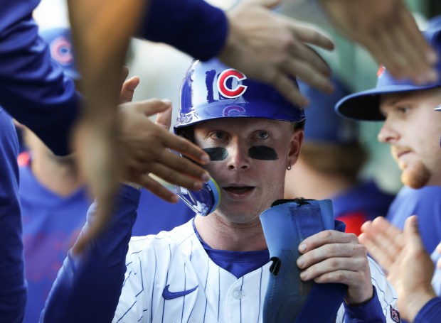 Cubs center fielder Pete Crow-Armstrong is congratulated after scoring off a two-run double from shortstop Dansby Swanson against the Braves in the sixth inning at Wrigley Field on Sept. 1, 2025, in Chicago. (John J. Kim/Chicago Tribune)