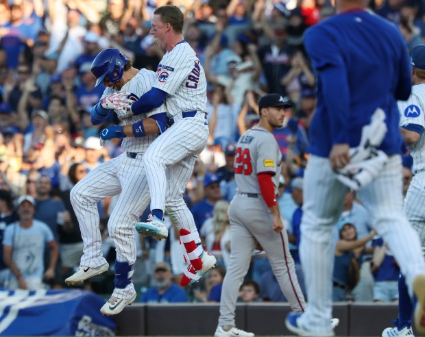 Cubs catcher Carson Kelly, left, is congratulated by center fielder Pete Crow-Armstrong after hitting a game-winning RBI single in the tenth inning against the Braves at Wrigley Field on Sept. 1, 2025, in Chicago. (John J. Kim/Chicago Tribune)
