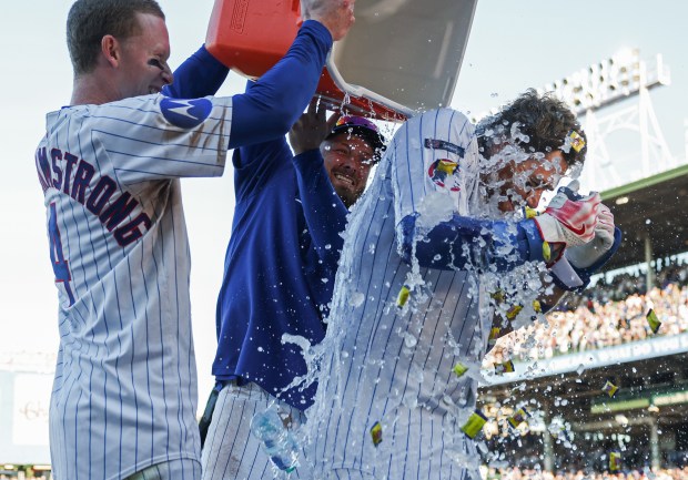 Cubs catcher Carson Kelly gets doused with ice water and bubble gum during an interview after hitting a game-winning RBI single in the tenth inning against the Braves at Wrigley Field on Sept. 1, 2025, in Chicago. (John J. Kim/Chicago Tribune)