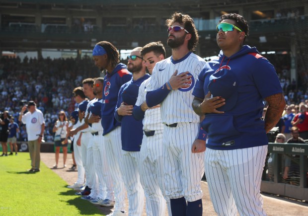 Cubs player Moisés Ballesteros, right, and teammates stand for the national anthem before a game against the Cardinals at Wrigley Field on Sept. 27, 2025, in Chicago. (John J. Kim/Chicago Tribune)