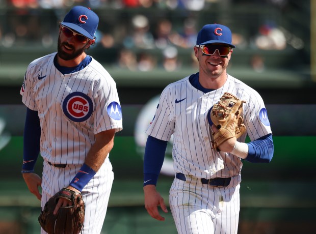 Cubs second baseman Nico Hoerner, right, smiles while heading to the dugout after fielding a line drive from Cardinals right fielder Jordan Walker in the second inning at Wrigley Field on Sept. 27, 2025, in Chicago. (John J. Kim/Chicago Tribune)