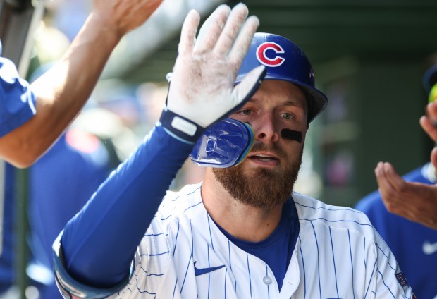 Cubs first baseman Michael Busch is congratulated after hitting a solo home run against the Cardinals in the first inning at Wrigley Field on Sept. 27, 2025, in Chicago. (John J. Kim/Chicago Tribune)