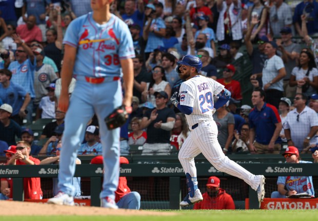 Cubs first baseman Michael Busch rounds the bases after hitting a two-run home run off Cardinals starting pitcher Michael McGreevy, left, in the fifth inning at Wrigley Field on Sept. 27, 2025, in Chicago. (John J. Kim/Chicago Tribune)