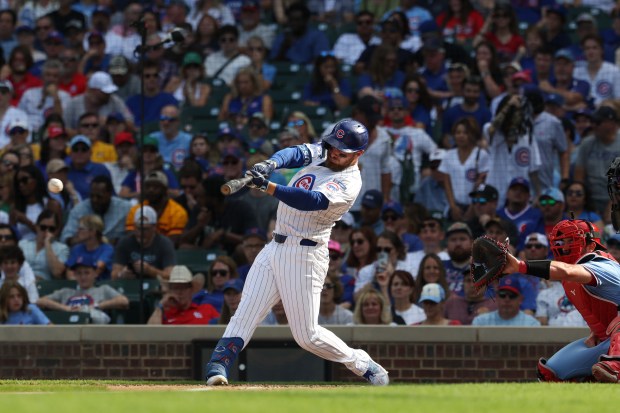 Cubs first baseman Michael Busch connects for an RBI triple in the seventh inning against the Cardinals at Wrigley Field on Sept. 27, 2025, in Chicago. (John J. Kim/Chicago Tribune)