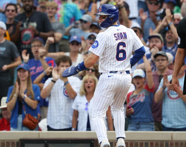 Cubs third baseman Matt Shaw looks toward third base to see first baseman Michael Busch's position after scoring off a triple from Busch in the seventh inning against the Cardinals at Wrigley Field on Sept. 27, 2025, in Chicago. (John J. Kim/Chicago Tribune)