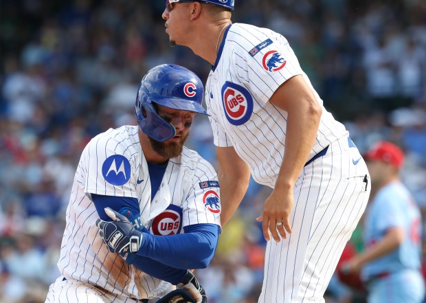 Cubs first baseman Michael Busch rises from the bag after hitting an RBI triple in the seventh inning against the Cardinals at Wrigley Field on Sept. 27, 2025, in Chicago. (John J. Kim/Chicago Tribune)