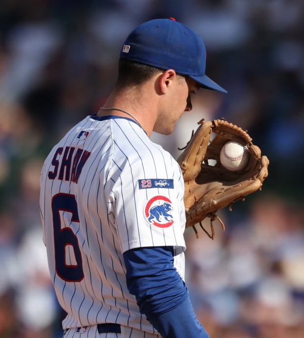 A grounder hit by Cardinals second baseman Nolan Gorman remains stuck in Cubs third baseman Matt Shaw's glove web, resulting in a single for Gorman, in the ninth inning at Wrigley Field on Sept. 27, 2025, in Chicago. (John J. Kim/Chicago Tribune)
