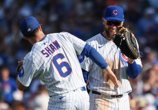 Cubs third baseman Matt Shaw and first baseman Michael Busch celebrate a 7-3 win over the Cardinals at Wrigley Field on Sept. 27, 2025, in Chicago. (John J. Kim/Chicago Tribune)