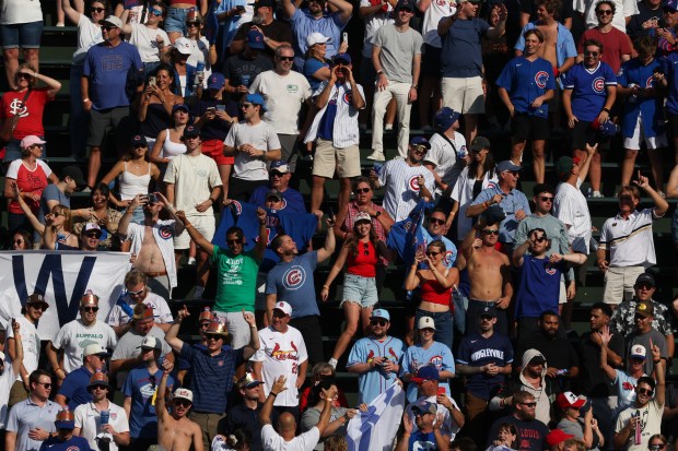 Cubs fans celebrate a 7-3 win over the Cardinals at Wrigley Field on Sept. 27, 2025, in Chicago. (John J. Kim/Chicago Tribune)